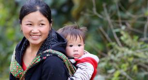 Smiling woman supported by Women Livelihood Bond